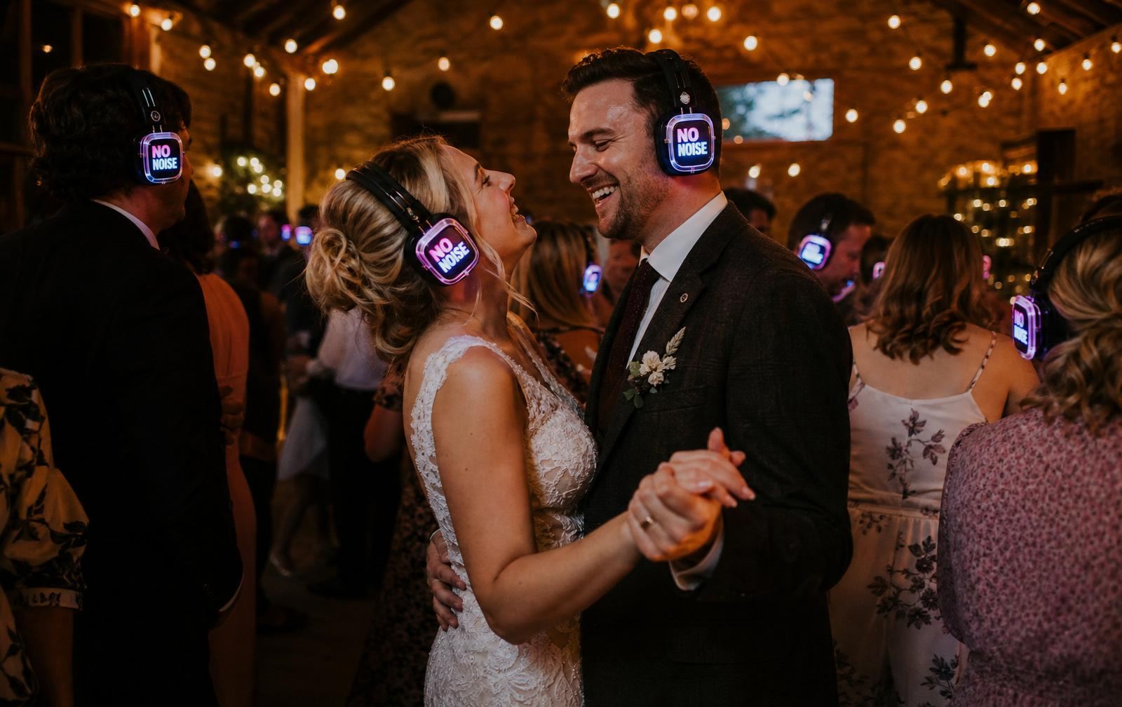 Wedding reception silent disco hire in Devon — guests dancing with glowing LED headphones
